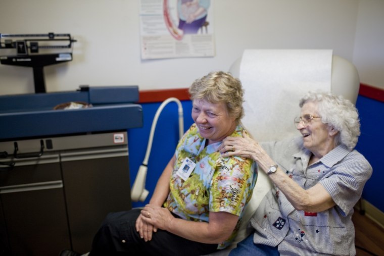 Nurse practitioner Mary Fey receives a back rub from her patient Willetta Crosby at the Dexter Clinic run by Peace Health, in Dexter., Or., on July 10...