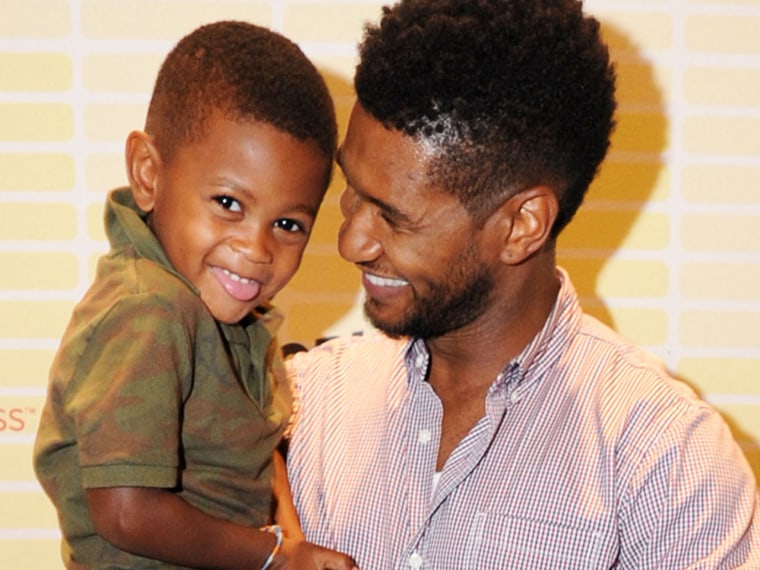Usher and his son, Usher Raymond V, attend a conference for the singer's foundation in Atlanta on July 21.