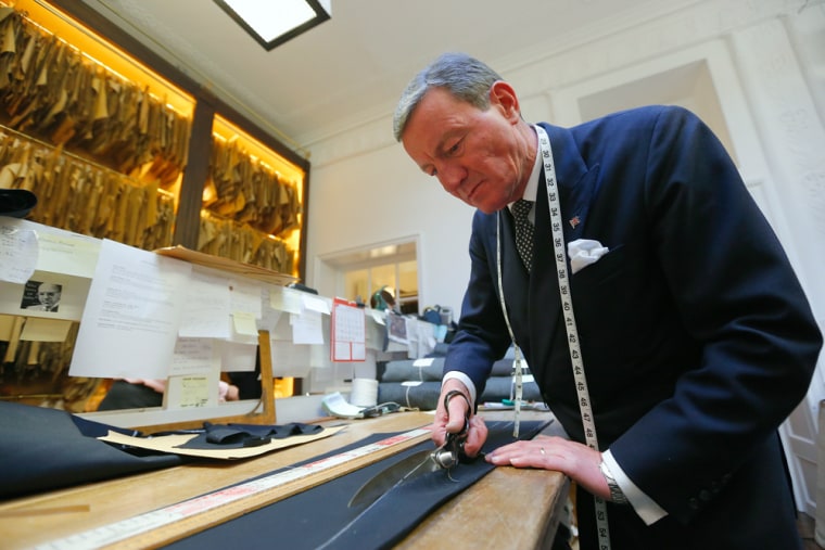 Head trouser cutter John Malone cuts cloth for a suit at bespoke Savile Row tailors Anderson & Sheppard in central London February 14, 2013. Anderson ...