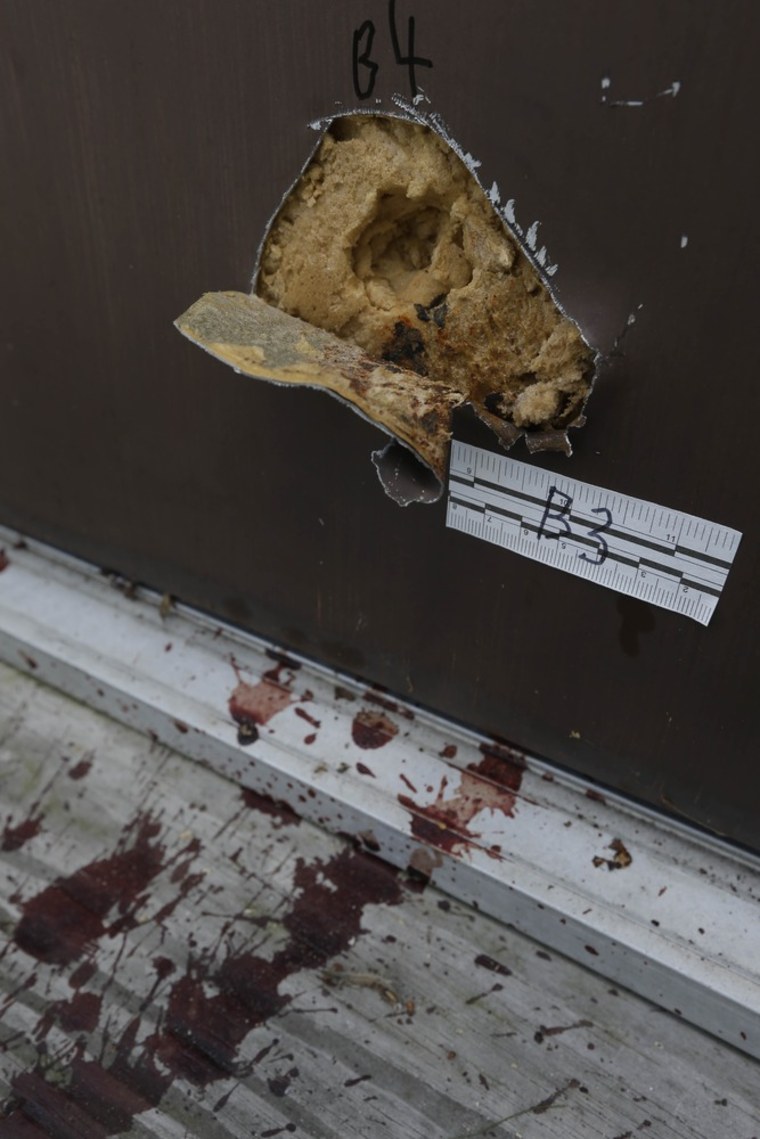 Blood is seen by a side doorway, Tuesday, Aug. 6, 2013, where a shooting occurred Monday night at the Ross Township Municipal Building in Saylorsburg, Pa.