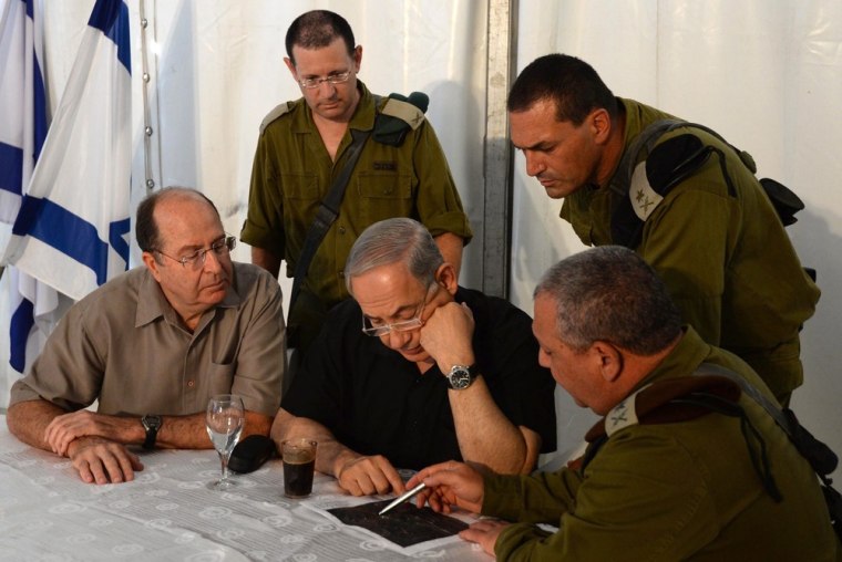 Israeli Prime Minister Benjamin Netanyahu (center) is briefed on the explosion at a military base in southern Israel Wednesday.