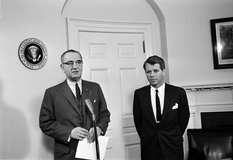 President Johnson commends Attorney General Robert F. Kennedy, right, on his peacemaking mission to Southeast Asia at the White House, Jan. 28, 1964. Kennedy gave President Johnson an 80 minute report before the commendation.