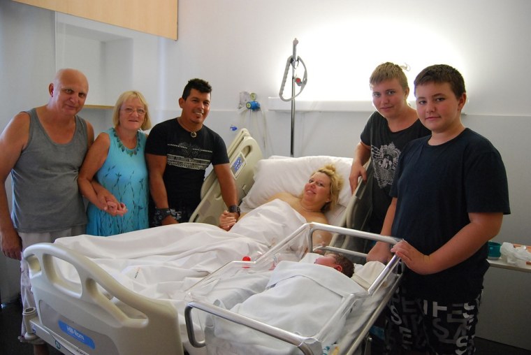 Mother Maxime Marin is surrounded by family members after giving birth to Maria Lorena Marin