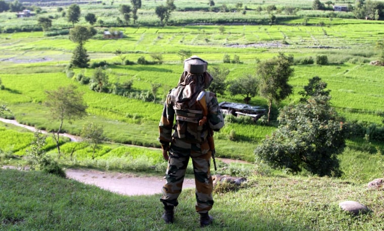 An Indian Army soldier stands guard as he patrols near the Line of Control (LoC) of Pakistan occupied Kashmir, Thursday.