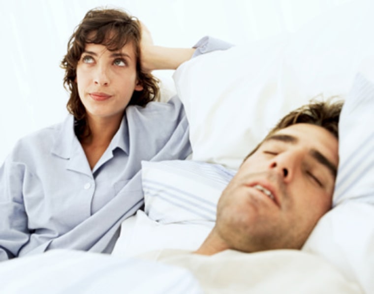 woman frustrated annoyed at man's snoring man bed couple pajamas sleep awake msnbc stock photography photo realtionship insomnia