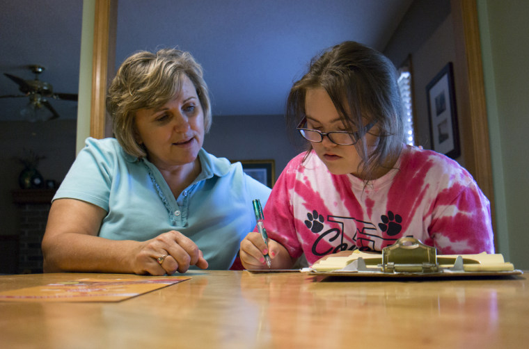 Jawanda Mast helps her daughter Rachel, 14, write thank you notes at their home in Olathe, KS, on Aug. 6, 2013. Rachel has Downs Syndrome.