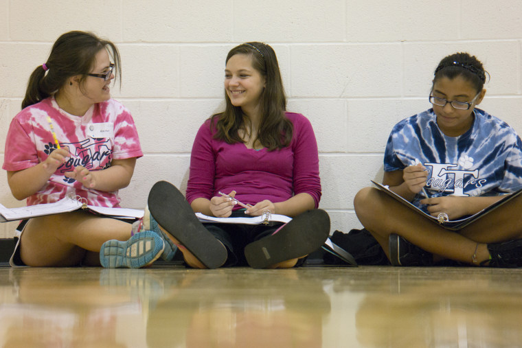 At left, Rachel Mast, 14, in training with other students at her middle school to become student ambassadors to incoming sixth graders on Aug. 6, 2013...
