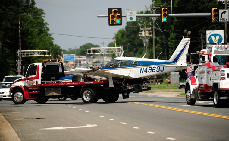 The crashed airplane is hauled to Shannon Airport along Tidewater Trail on Monday afternoon.