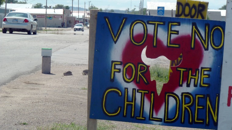 A sign outside Whiteclay, Neb., urges Pine Ridge Indian Reservation residents to oppose the legalization of alcohol sales on Aug. 8.