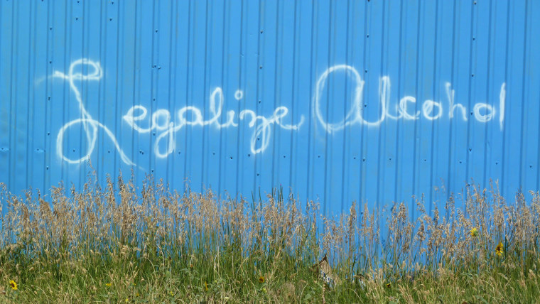 A sign on a building in Whiteclay, Neb., urges Pine Ridge Indian Reservation residents to approve the legalization of alcohol sales.