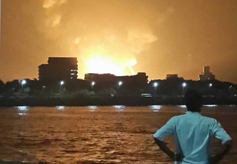 Flames from the INS Sindhurakshak burn in Mumbai, India, late on Wednesday.