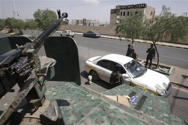 This Aug. 10, 2013 file photo shows Yemeni soldiers inspecting a car at a checkpoint on a street leading to the U.S. and British embassies in Sanaa, Yemen. In secretive chat rooms and on encrypted Internet message boards, al-Qaida fighters have been planning and coordinating attacks _ including a threatened if vague plot that U.S. intelligence officials say closed 19 embassies across Africa and the Middle East for more than a week.