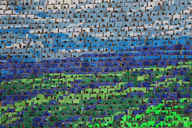 The Arirang games flashcard mosaics usually have patriotic themes. This year's theme highlights the exploits of North Korean soldiers in the 1950-1953 war. What you don't see on television or even across May Day stadium, unless you have a long camera lens or binoculars, are the heads of some of the boys popping up above their flashcards. I'm not sure if they were allowed to peek, but perhaps they wanted to see the big show on the field for themselves.