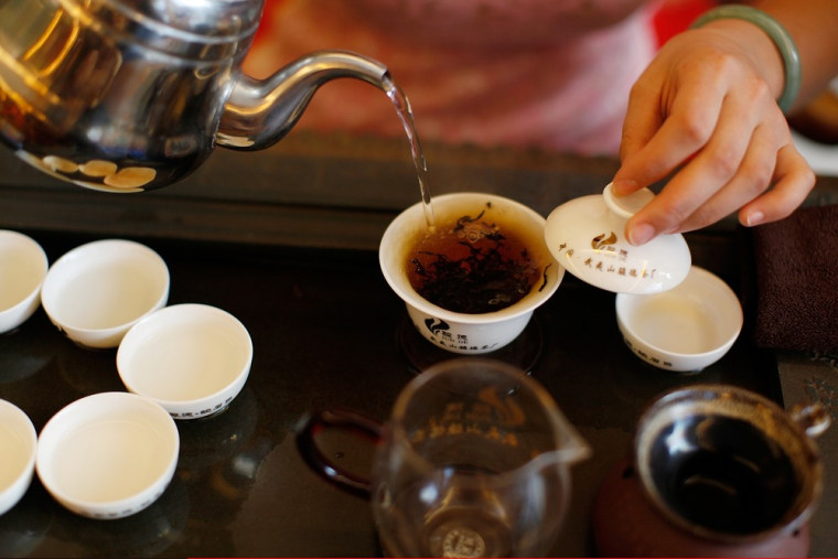 A woman brews tea at tea room on May 11, 2012 in Wuyishan, Fujian province, southeastern China. Wuyi Mountains is renowned for producing top quality t...