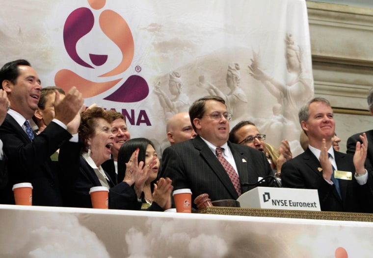 Executives and guests of Teavana, a chain of retail tea shops, applaud as CEO Andrew T. Mack, second from right, rings the New York Stock Exchange ope...