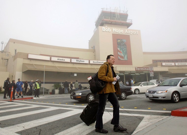 Andy Peters leaves Bob Hope Airport, which was closed due to fog, in Burbank, Calif., Monday, Nov. 19, 2007, after his flight was canceled. Peters mad...