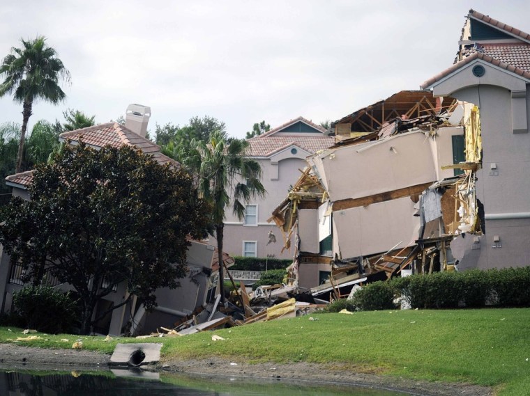 A section of the Summer Bay Resort lies collapsed after a large sinkhole opened on the property's grounds in Clermont, Fla. on Aug. 12.