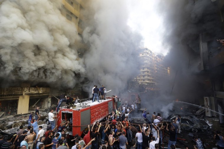 Lebanese citizens and Hezbollah supporters gather at the scene of a car bomb explosion in southern Beirut, Lebanon, on Aug. 15.
