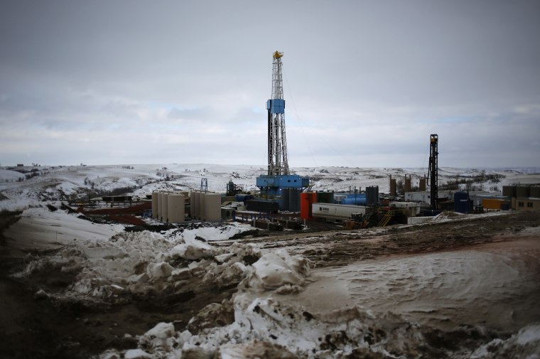 An oil derrick is seen at a fracking site for extracting oil outside of Williston, North Dakota March 11, 2013. An oil derrick is a complex set of mac...