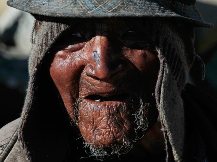 Carmelo Flores Laura, a native Aymara, speaks during an interview outside his home in the village of Frasquia, Bolivia, Tuesday, Aug. 13, 2013. If Bolivia's public records are correct, Flores is the oldest living person ever documented. They say he turned 123 a month ago. To what does the cattle and sheepherder owe his longevity?