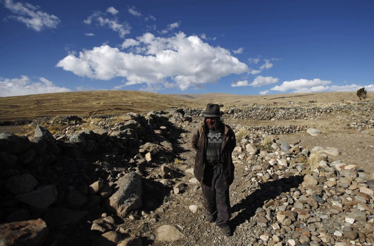 Carmelo Flores Laura, a native Aymara, walks near his home in the village of Frasquia, Bolivia, Tuesday, Aug. 13, 2013. If Bolivia's public records are correct, Flores is the oldest living person ever documented. They say he turned 123 a month ago. To what does the cattle and sheepherder owe his longevity?