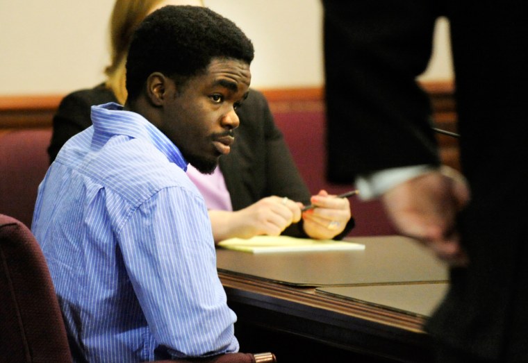 De'Marquise Elkins, center, listens to proceedings during his bond hearing while sitting next to his lawyer Defense Attorney Kevin Gough, right, Friday April 5, 2013 in Brunswick, Ga.