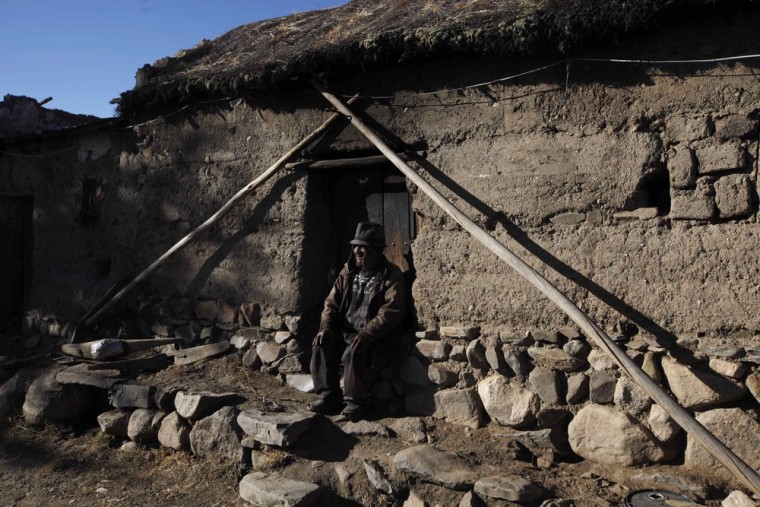 Carmelo Flores Laura, a native Aymara, sits outside his home in the village of Frasquia, Bolivia, Tuesday, Aug. 13, 2013. If Bolivia's public records are correct, Flores is the oldest living person ever documented.