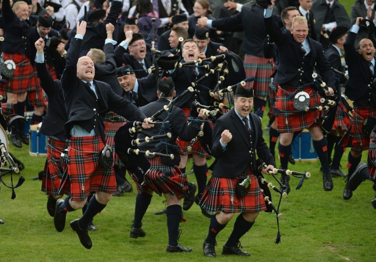 Members of the Field Marshall Montgomery pipe band celebrate winning the 2013 World Pipe Band Championships at Glasgow Green in Glasgow, Scotland, on Aug. 18, 2013.