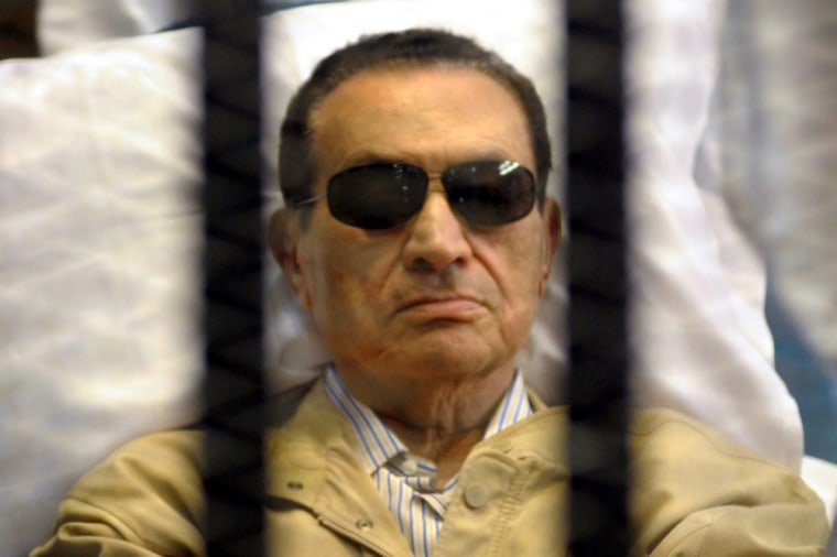 Former Egyptian president Hosni Mubarak on a stretcher inside a Cairo court room in June 2012.