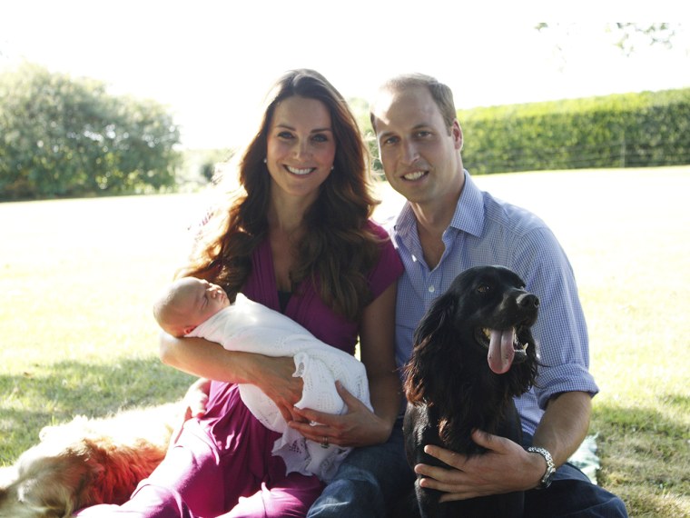 Happy family: Prince William and Duchess Kate, holding son George, relax with Tilly, a Middleton family pet, and Lupo, the couple’s cocker spaniel.