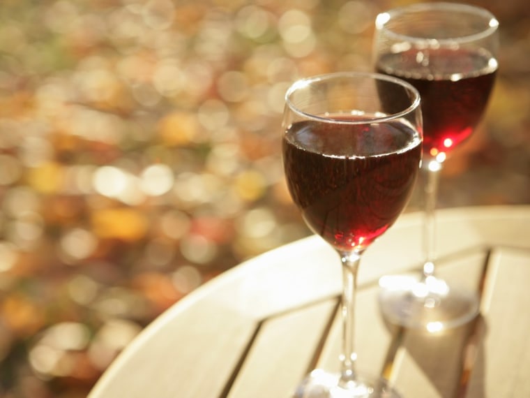 Two glasses of red wine on table , outside