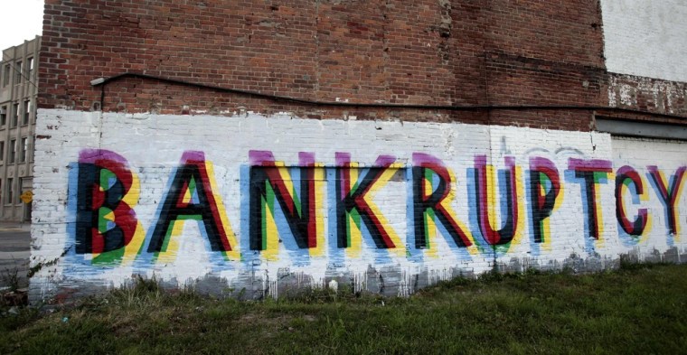 The word 'Bankruptcy' is seen painted on the side of a vacant building by street artists as a statement on the financial affairs of the city on Grand ...