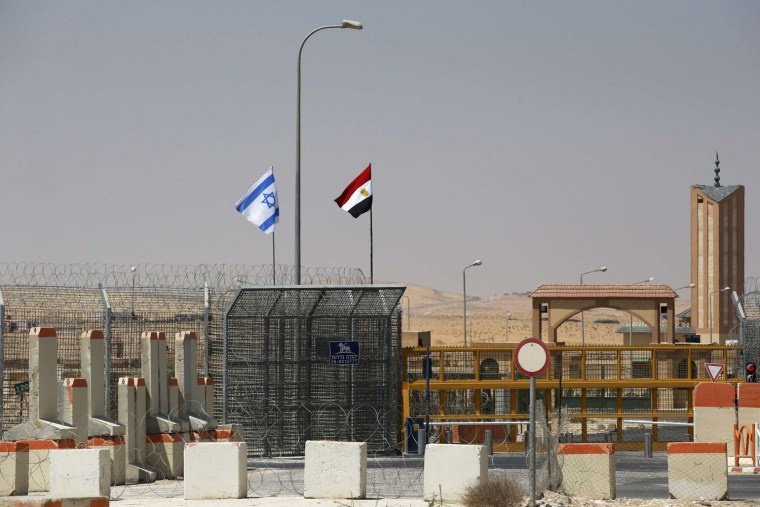 An Israeli flag, left,  flutters next to an Egyptian one at the Nitzana crossing, along Israel's border with Egypt's Sinai desert, as seen from the Israeli side on Tuesday.
