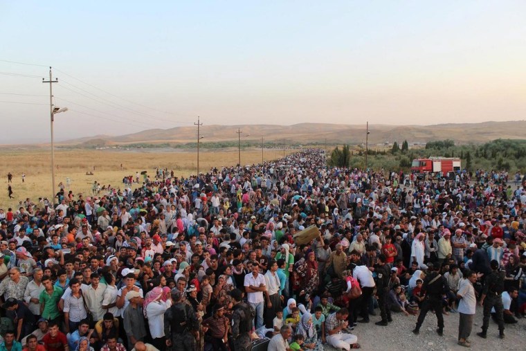 Thousands of Syrians streaming across a bridge over the Tigris River, entering Iraq at a point where movement is normally tightly controlled by both countries, on Aug. 15.