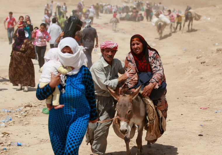Syrian refugees cross into Iraq at the Peshkhabour border point in Dahuk, 260 miles northwest of Baghdad, on Aug. 20, 2013.