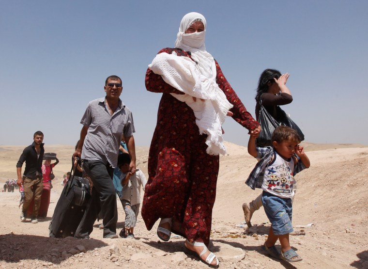 Syrian refugees cross into Iraq on Aug. 20, 2013. Around 4,000 made the trek across the frontier Tuesday, said Youssef Mahmoud, a spokesman for the UNHCR.