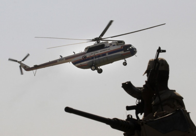 A soldier stands guard as the helicopter carrying Hosni Mubarak lands at Maadi Military Hospital.