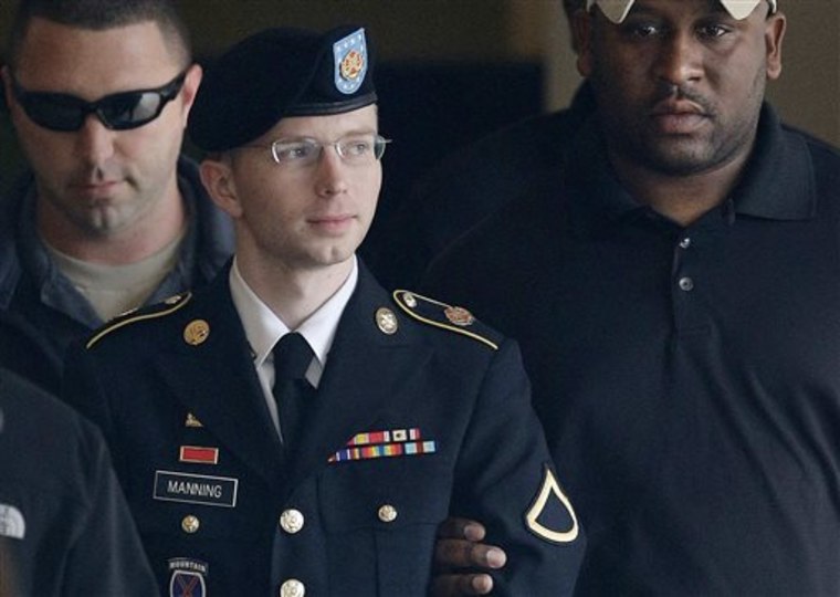 FILE - In this Tuesday, Aug. 20, 2013 file photo, Army Pfc. Bradley Manning is escorted to a security vehicle outside a courthouse in Fort Meade, Md.,...