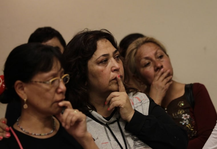 Relatives of the 12 missing people attend a news conference revealing the discovery of seven bodies in the grave.