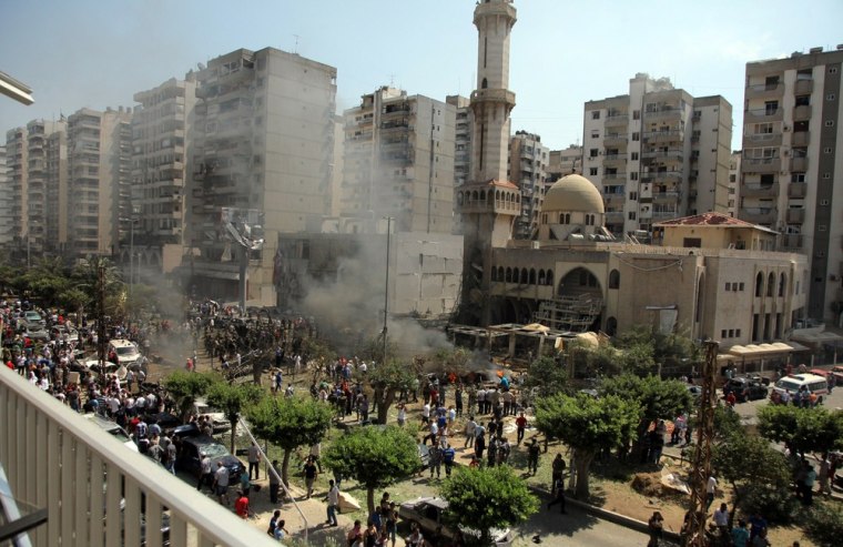 Lebanese citizens gather outside al-Salam mosque after a powerful explosion rocked the area in Tripoli.