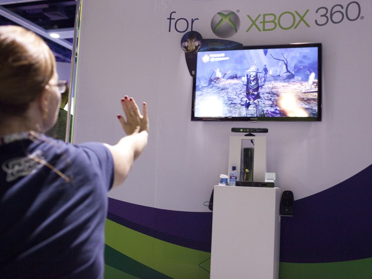 Monica Rysavy plays Fable with gestures from her hand toward the X-Box 360 Kinect console during Seattle's PAX Convention, Aug. 31, 2012. Kyle Bruggem...