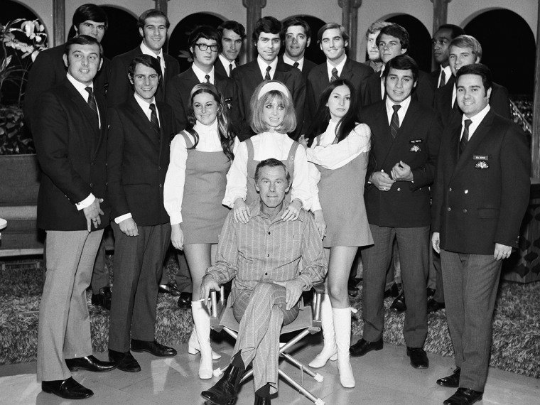 THE TONIGHT SHOW STARRING JOHNNY CARSON -- \"Season 9\" -- Pictured: Host Johnny Carson (seated) with NBC Pages in 1970 -- Photo by: Fred Sabine/NBC/NBC...
