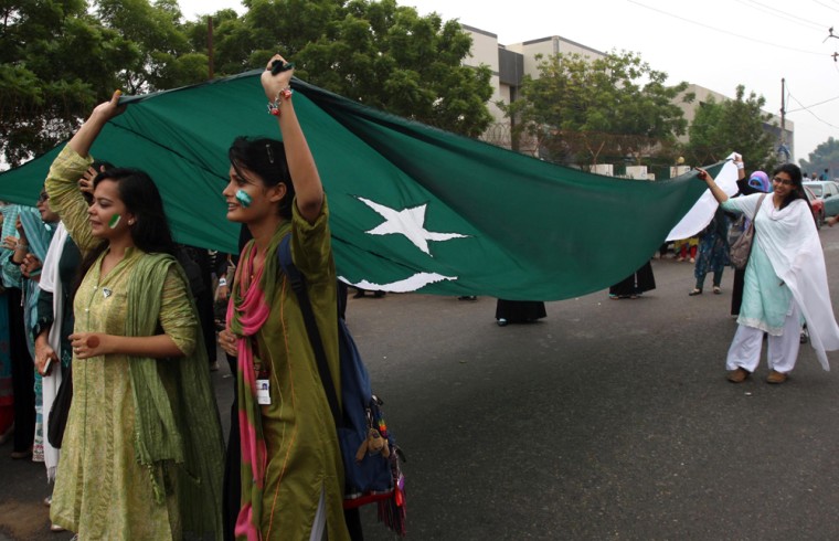 Students display Pakistan's national flag as they celebrate the eve of Independence Day in Karachi, Pakistan, on Aug. 13.