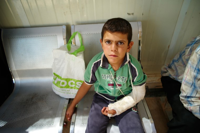 Jalal, 7, has been at the Za'atari refugee camp in Jordan for six weeks. His arm was injured in an attack in his hometown of Da'ara, Syria.