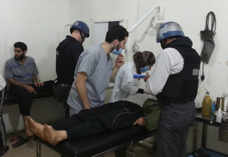 U.N. chemical weapons experts visit apparent victims of a gas attack on Monday at a hospital in the southwestern Damascus suburb of Mouadamiya.