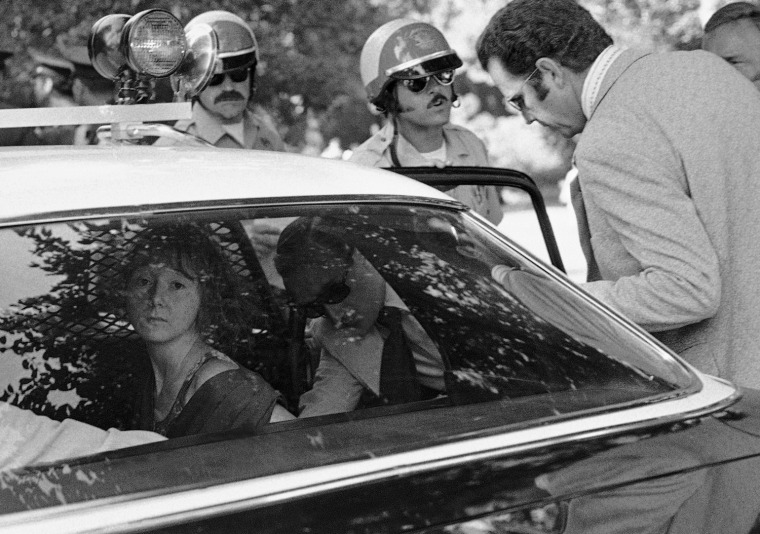 Lynette Fromme looks out from a police car following her arrest.