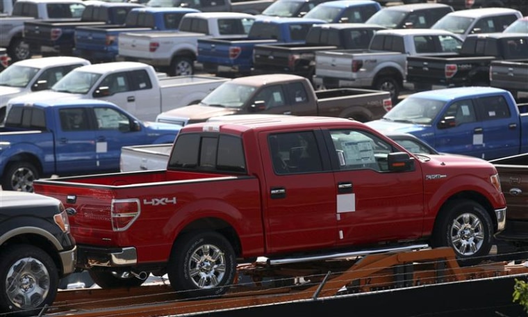Newly assembled Ford F150 pick-up trucks sit in a holding area before being transported to dealerships outside the Ford Rouge Center in Dearborn, Mich...