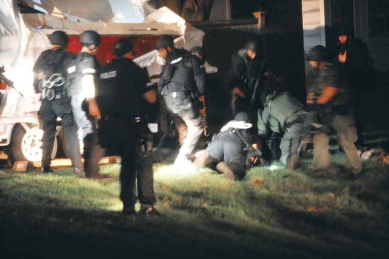 Law enforcement officials apprehend Boston Marathon bombing suspect Dzhokhar Tsarnaev at the time of his capture in Watertown, Mass., on April 19, 2013.