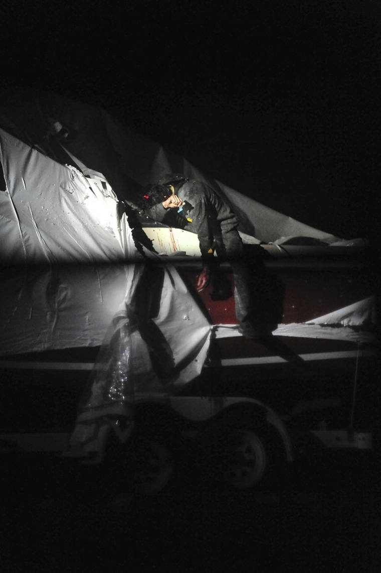 Boston Marathon bombing suspect Dzhokhar Tsarnaev leans over in a boat at the time of his capture by law enforcement authorities in Watertown, Mass., on April 19, 2013.