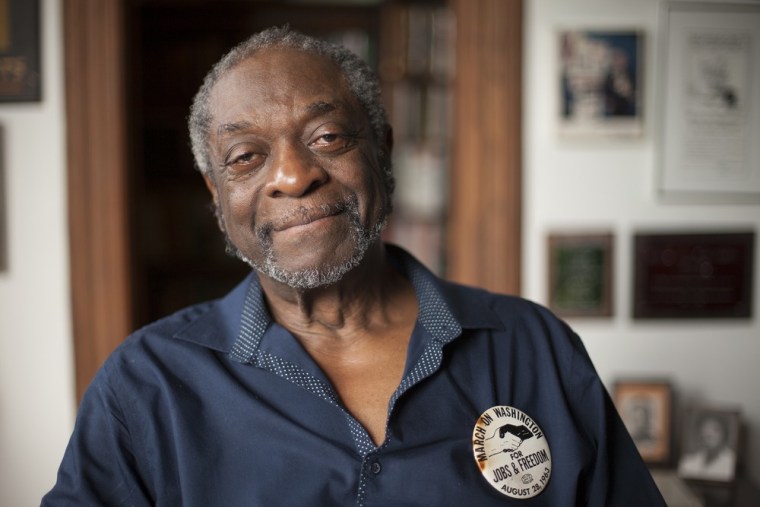 Les Payne, seen here at his home in Harlem, wears a button from the 1963 March on Washington, which he attended. For years before Dr. Martin Luther King, Jr.'s birthday was observed as a national holiday, Payne and his wife would keep their children home on that day and teach them about the civil rights leader and his legacy.